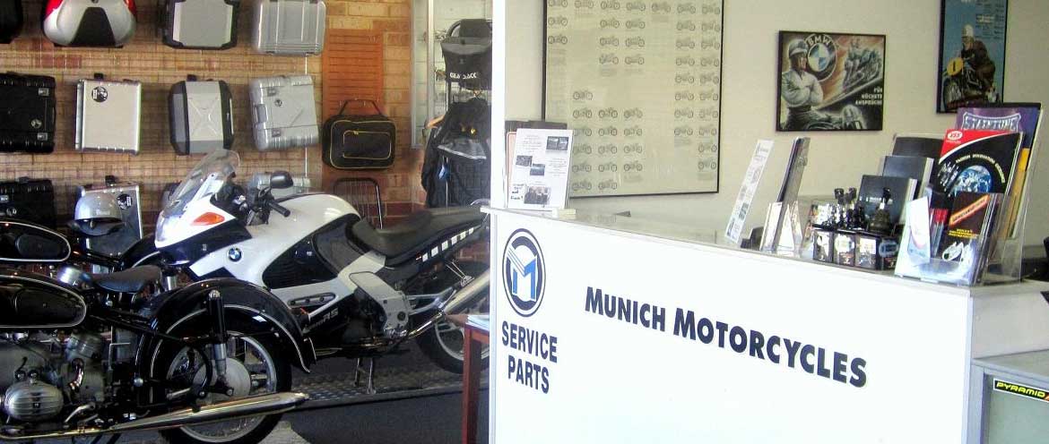 The Munich Motorcycles parts counter in Myaree, with a classic BMW and a K 1200 RS in front of a wall of panniers